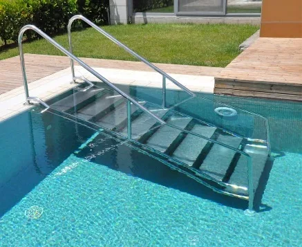 Close-up of a flanged stainless steel pool ladder — wide non-slip treads and flange-plate mounting